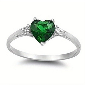 Detail view of heart-shaped green gemstone ring with side diamond accents on silver band