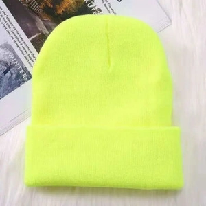 Close-up of neon yellow knit beanie showing detailed ribbed texture on white fleece