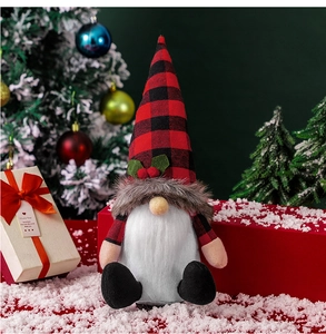 Detailed view of a Nordic Christmas gnome plush doll with red plaid hat and holly leaves