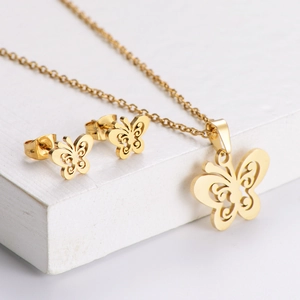 Titanium steel hollow butterfly jewelry set with necklace and earrings on white pedestal