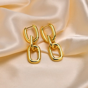 Elegant 18k gold plated chain link hoop earrings displayed on soft beige silk fabric