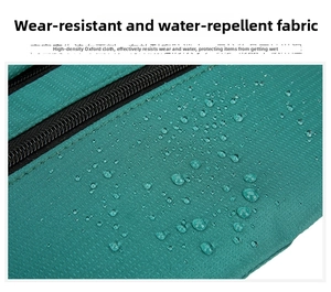 Detail of high-density oxford fabric showing water-resistant droplets on a dark green waist bag