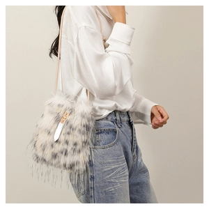 Detail of white and grey leopard print faux fur shoulder bag with drawstring closure
