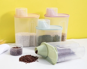 Detail of four airtight plastic food storage containers with colored lids for kitchen grains