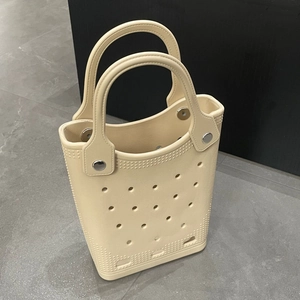 Detail view of beige EVA beach bag showing waterproof texture and silver rivet fasteners