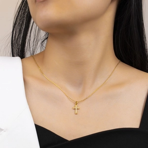 Chic hip hop gold cross pendant necklace for women worn by a model in a modern style