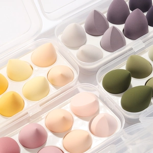 Set of 8 soft teardrop makeup sponges in Morandi colors with clear storage container