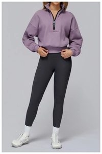 Close-up of women's purple half-zip sweatshirt with stand collar and long sleeves