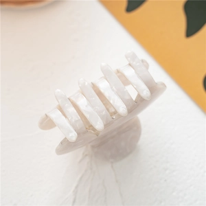 Elegant white marble acetate hair claw clip for women in a minimalist retro style