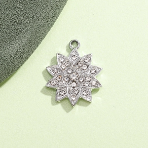 Macro detail of silver-plated snowflake pendant with sparkling rhinestones and petal texture