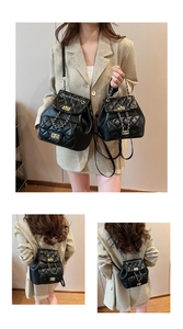 Detail view of black quilted chain backpack in two sizes with gold hardware
