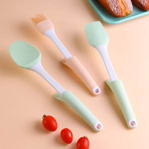 Detailed closeup of silicone kitchen spatula and brush set for baking and cooking.