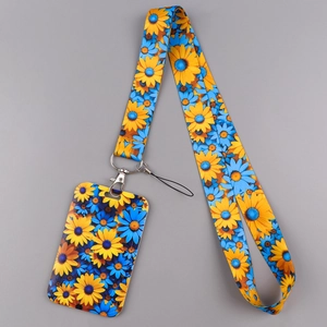 Detail of yellow sunflower floral lanyard and ID card holder with silver metal hook