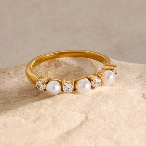 18k gold plated stainless steel ring with white pearls and zircons on a natural stone base