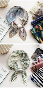 Detail of pleated silk scarves featuring mixed patterns and vibrant color textures