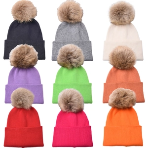 Grid showing nine various colors of children knit beanies with faux fur pom-poms