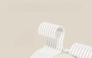 Detail of white clothes hanger hook with non-slip spiral texture and sturdy metal design
