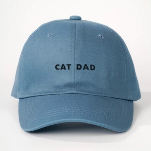 Close-up of CAT DAD black embroidery on cotton twill fabric of the blue baseball cap