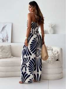 Detail of smocked waist jumpsuit with off-shoulder neckline and navy floral print