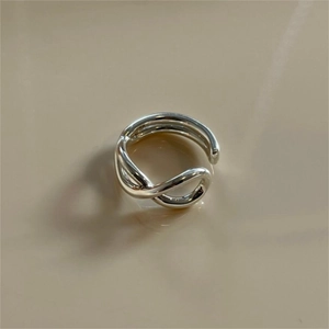 Macro detail of silver multi-layer twisted crossover open ring in 925 sterling silver