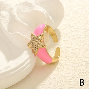 Detail of adjustable star ring featuring pink enamel and sparkling zircon accents