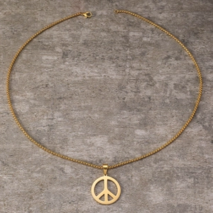 Detailed macro view of the gold-plated peace sign pendant on a stainless steel link chain