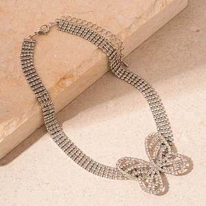 Macro detail of sparkling multi-row rhinestone butterfly choker with adjustable clasp