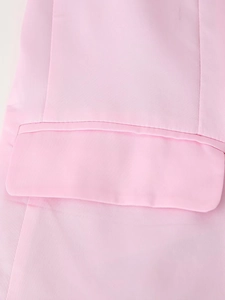 Close-up of pink satin suit jacket featuring elegant pocket stitching and fabric texture