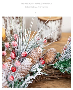 Detailed close-up of red berries, frosted pine needles, and pine cones on a rustic wreath