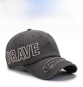 Detail of distressed brim and white Brave embroidery on washed gray baseball cap