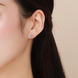 Elegant S925 sterling silver triangle stud earrings with sparkling cubic zirconia on model