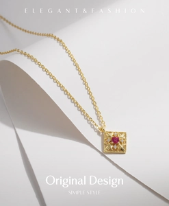 Close-up of a s925 silver square pendant necklace with red gemstone and hollow details