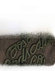 Detail shot of vintage washed baseball cap with 3D textured letter embroidery on knit fabric