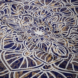 Detail shot of mandala tapestry fabric showing soft texture and intricate print