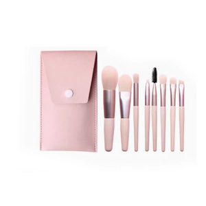 Pink 8-piece makeup brush set with elegant leather envelope storage pouch on white background