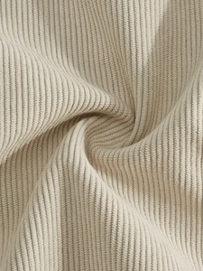 Macro detail of soft cream corduroy fabric texture showing vertical ribbed patterns