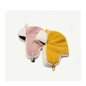 Detailed view of yellow and purple plush trapper hats with corduroy and warm fleece lining