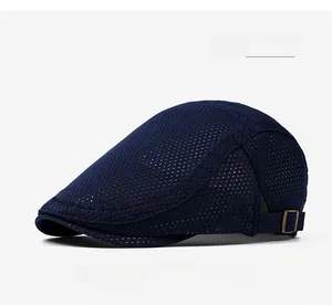 Close-up of navy blue mesh fabric texture and bronze metal buckle on the breathable newsboy hat