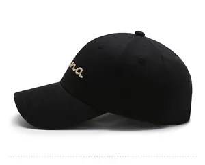 Detailed side view of black cotton baseball cap with gold 'ina' embroidery