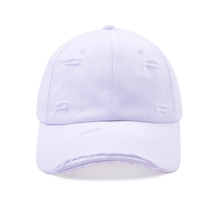Detail of distressed vintage baseball cap showing frayed holes and cotton twill texture