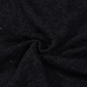 Close-up of black floral lace fabric with delicate hollow out patterns and soft texture
