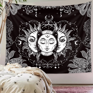 Detail view of Bohemian sun and moon tapestry hanging on a wall in a cozy bedroom