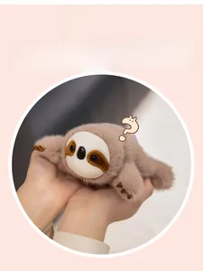 Macro detail of a plush sloth fridge magnet showing long brown faux fur and cute facial features