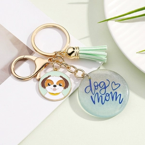 Detail of Dog Mom acrylic keychain with green tassel and golden lobster clasp