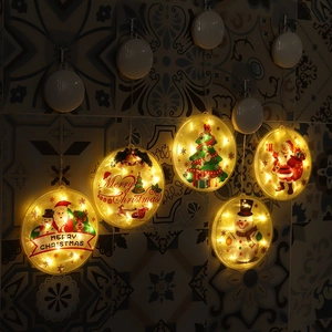 Detail of warm yellow LED hanging lights with Santa and snowman patterns for Christmas