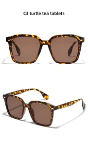 Detail view of oversized tortoiseshell sunglasses C3 with brown lenses and gold accents