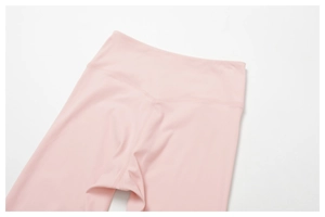 Detail of pink high-waisted yoga leggings showing wide waistband and V-seam stitching