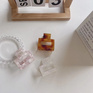 Chic French style acetate hair claw clips in amber, pink marble, and white pearl