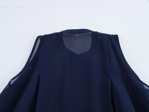 Detailed view of the sheer mesh patchwork on the back of this dark blue sleeveless chiffon top