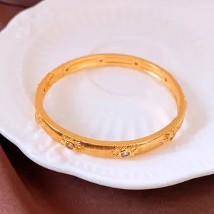 Vintage 24K gold plated brushed bangle with floral sunburst crystal carvings